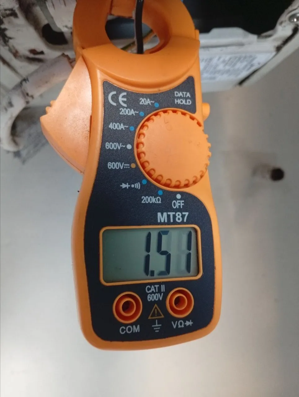 Clamp meter measuring AC current during diagnosis in Bali