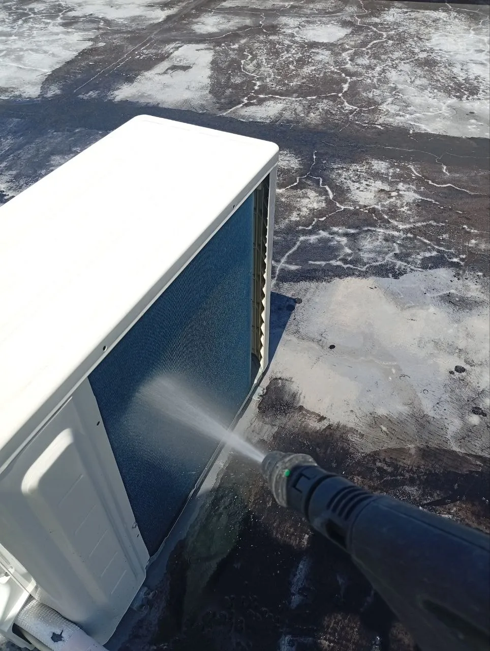 Scheduled outdoor AC condenser wash on a commercial rooftop in Bali